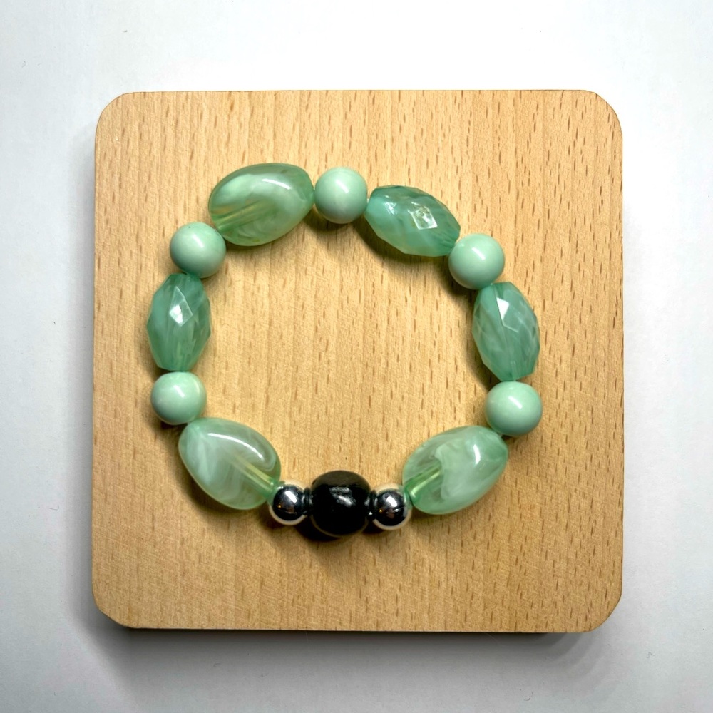 cute light green bracelet with black charm for woman